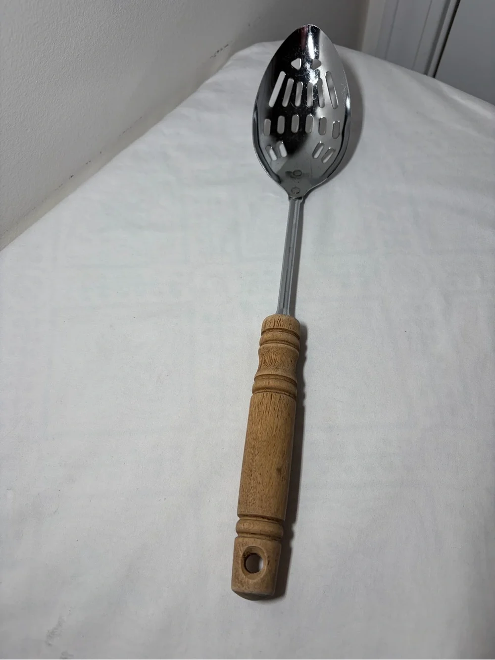 EKCO Stainless Steel Slotted Spoon, Brown Wood Handle, Silver Solid Pattern